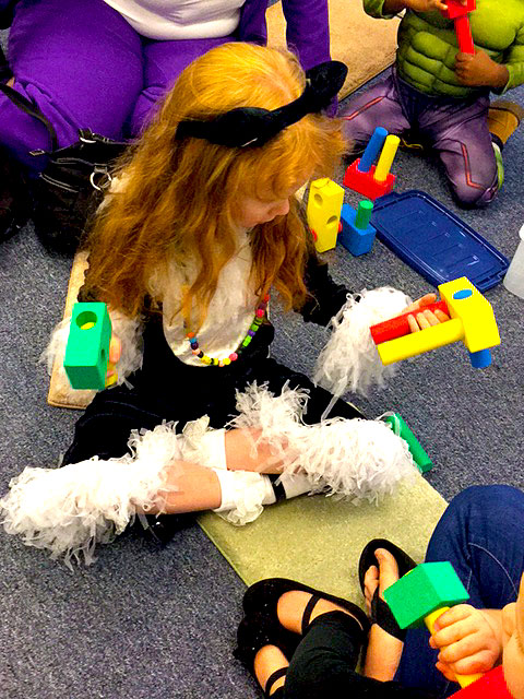 A child playing with tactile shapes and toys.